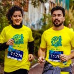 Two athletes participating in a marathon, showing determination and joy.